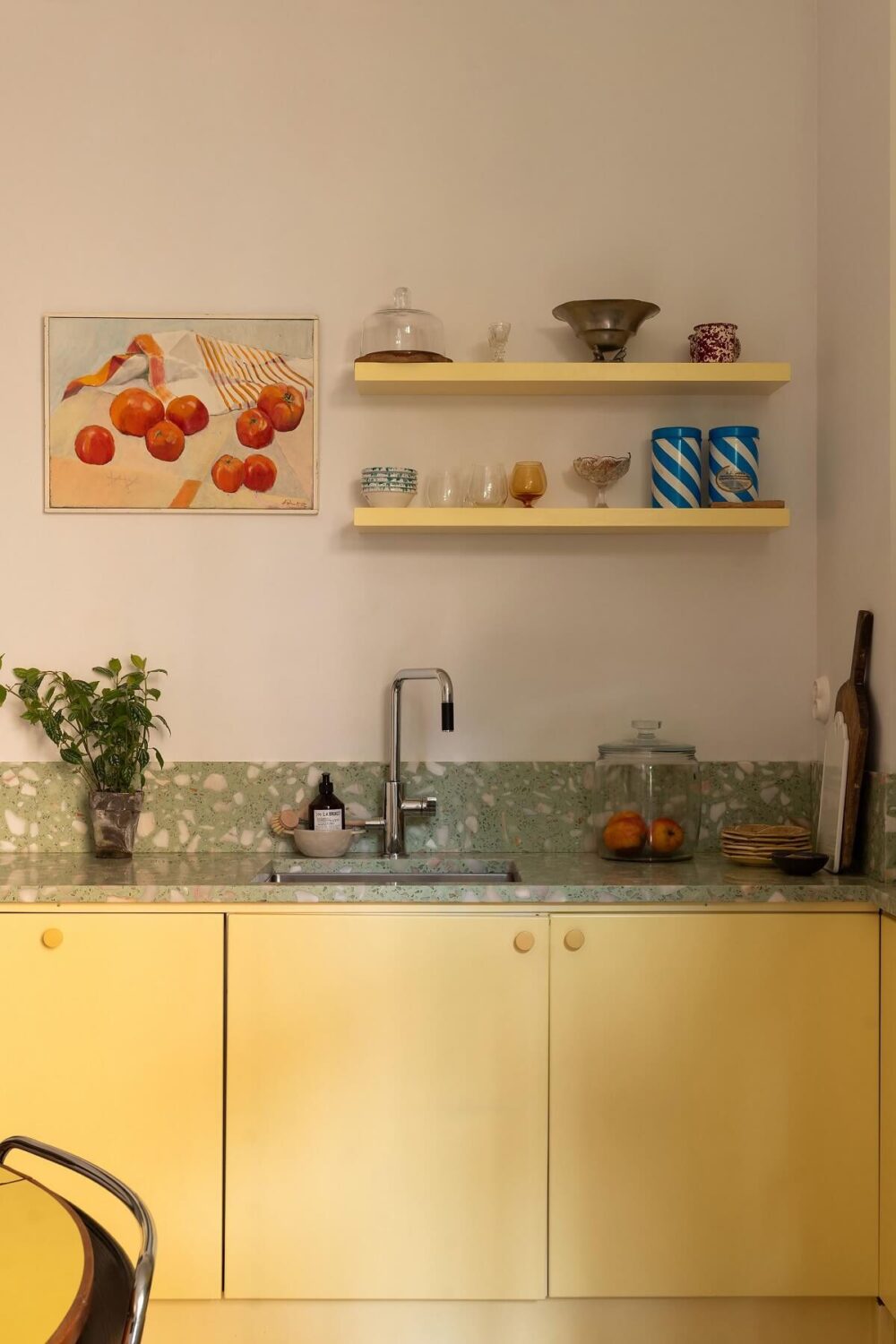 A Swedish Apartment with a Yellow Kitchen 5 yellow cupboards and green worktop
