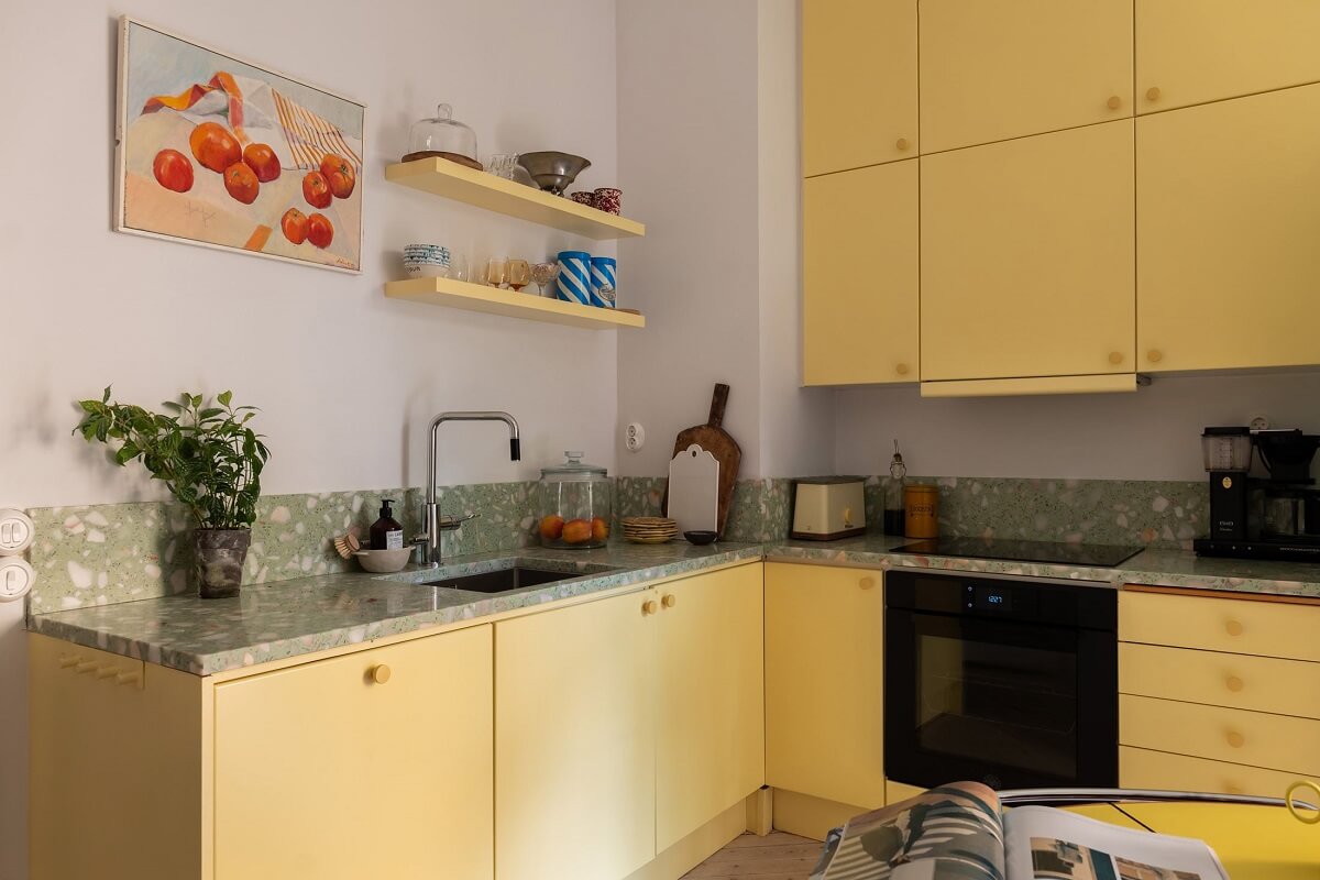 A Swedish Apartment with a Yellow Kitchen 4 yellow kitchen cabinets and green worktop