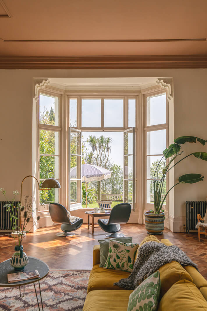 Grand Rooms and Vibrant Colors in an English Country Home 4 yellow sofa and large bay window in living room