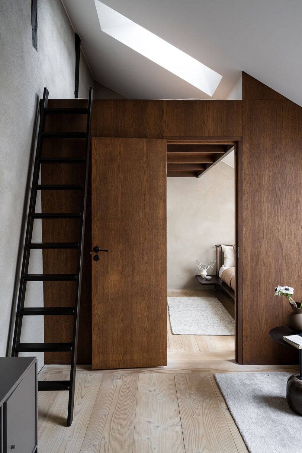 A Stylish Scandinavian Duplex with Custom-Made Cabinets 18 attic floor with wooden feature wall and loft space