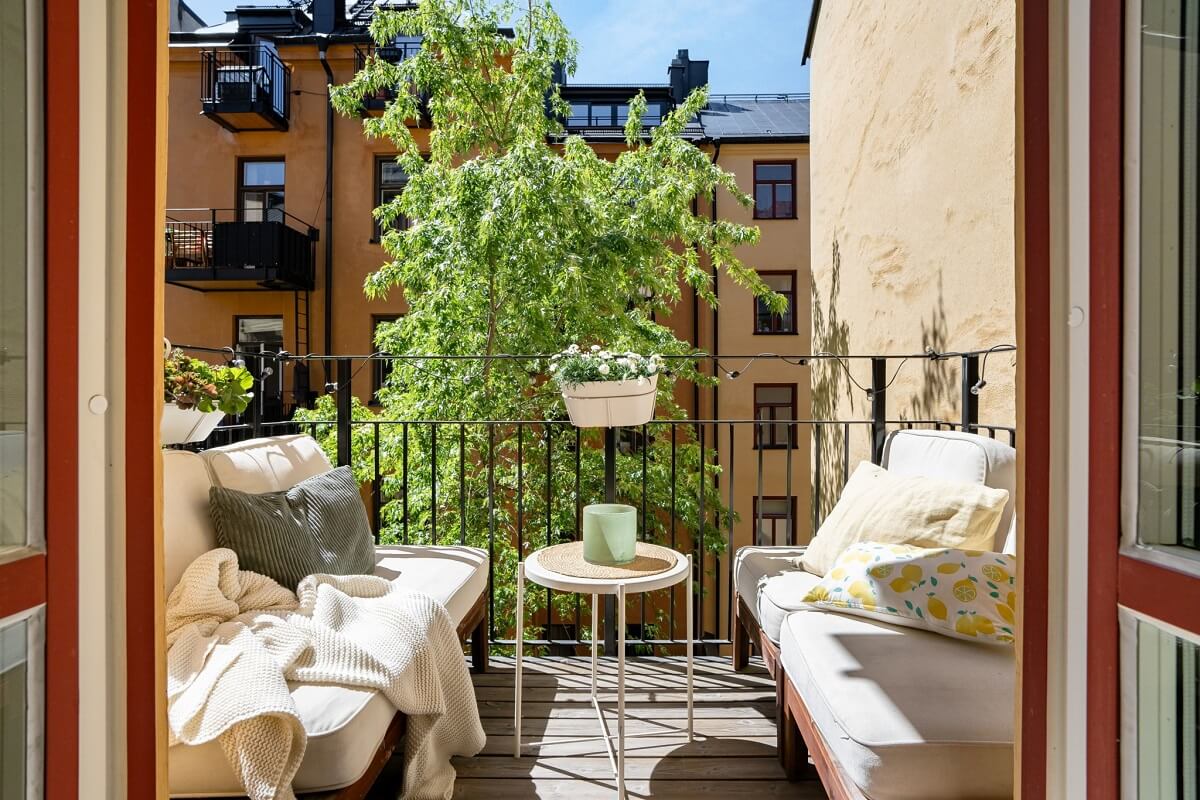 A Small Stockholm Apartment with a Gray Bedroom & Sunny Balcony 13 balcony with double seating benches