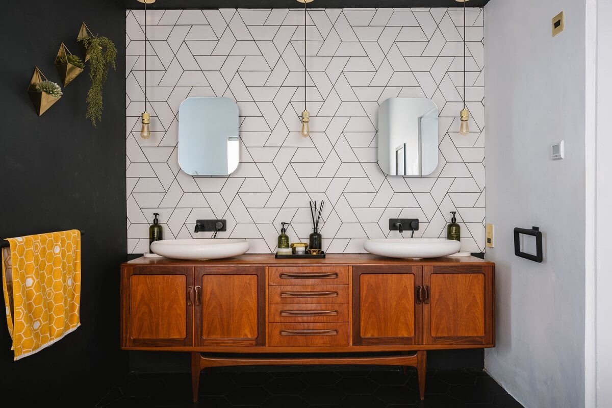 A Deep Blue Color Palette in a London Apartment 10 bathroom black wall vintage vanity and white tiles nordroom A Deep Blue Color Palette in a London Apartment