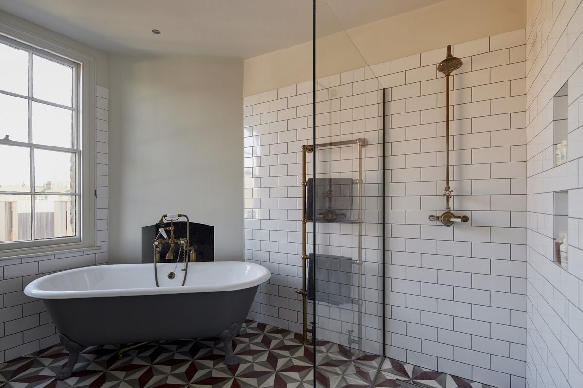A Georgian Townhouse with a Modern Concrete Extension 27 bathroom with colorful tiles and bath