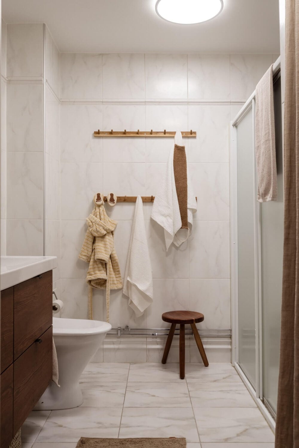 Warm Colors and Painted Ceilings in a Swedish Apartment 22 bathroom wooden ikea sink cabinet
