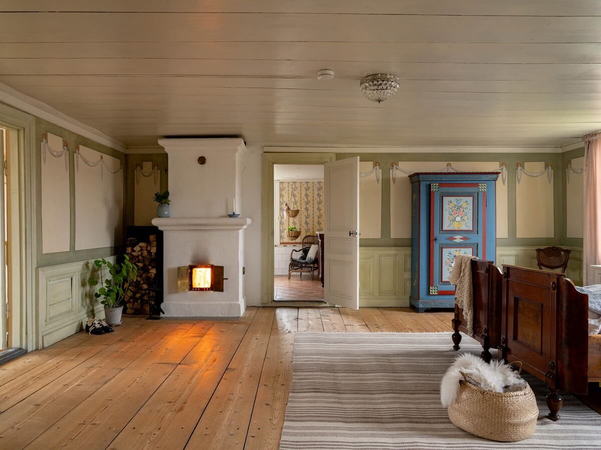 Original Character and Grand Rooms in a Swedish Country House 24 bedroom with antique wooden bed and fireplace