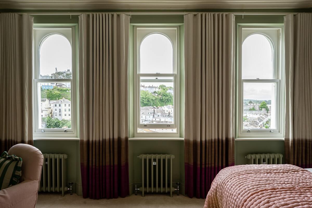Colorful Interiors and Wallpapers in a Victorian House 11 bedroom with arched windows