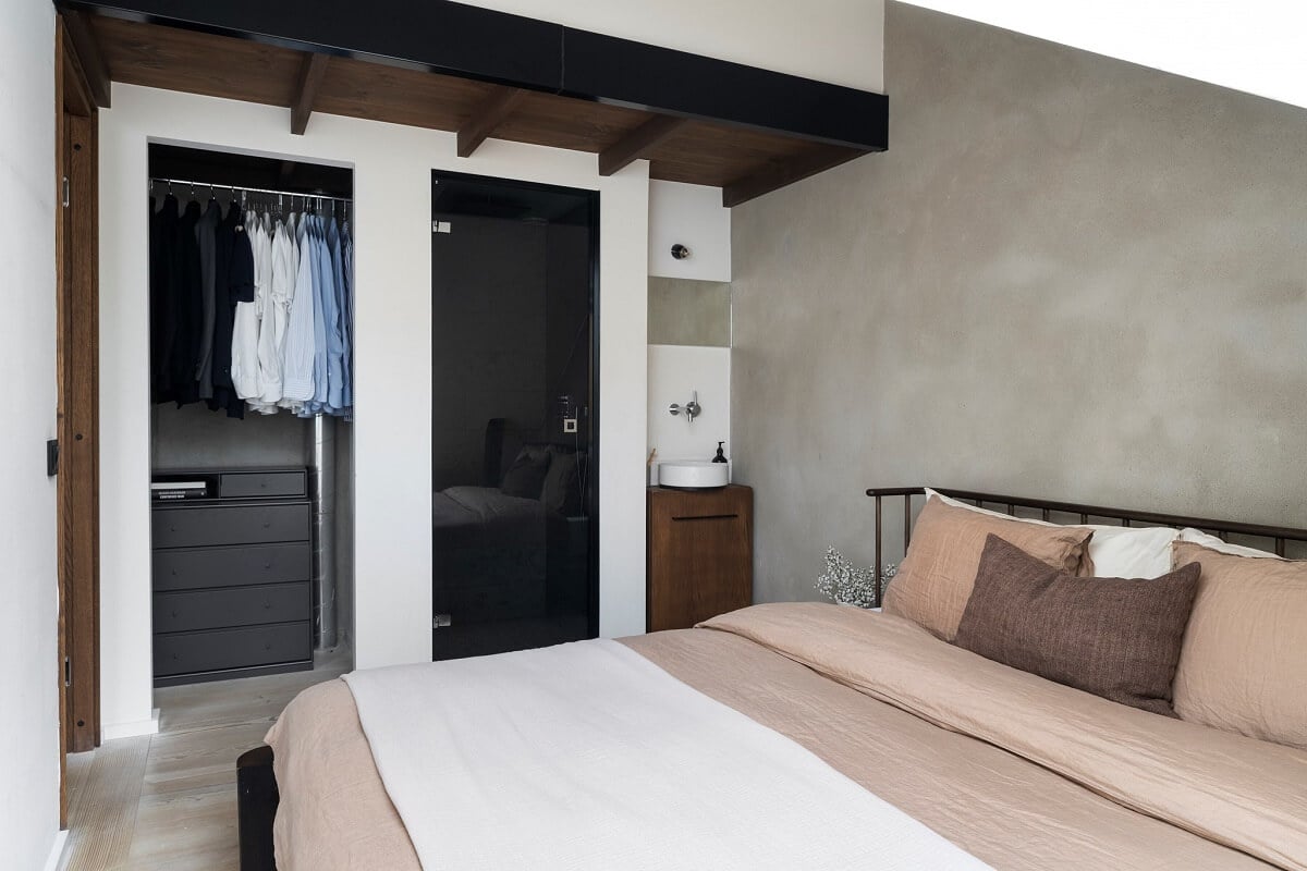 A Stylish Scandinavian Duplex with Custom-Made Cabinets 23 bedroom with slanted ceiling and wardrobes