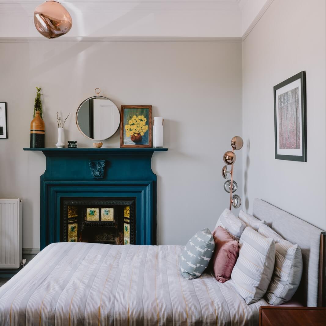 A Deep Blue Color Palette in a London Apartment 13 bedroom with teal blue fireplace A Deep Blue Color Palette in a London Apartment