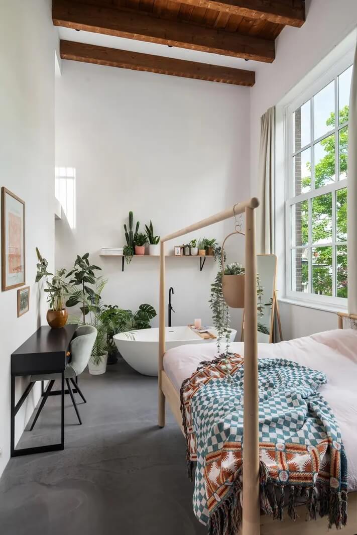 Loft Spaces in a Former School Conversion in Rotterdam 19 bedroom wooden ceiling freestanding bath plants