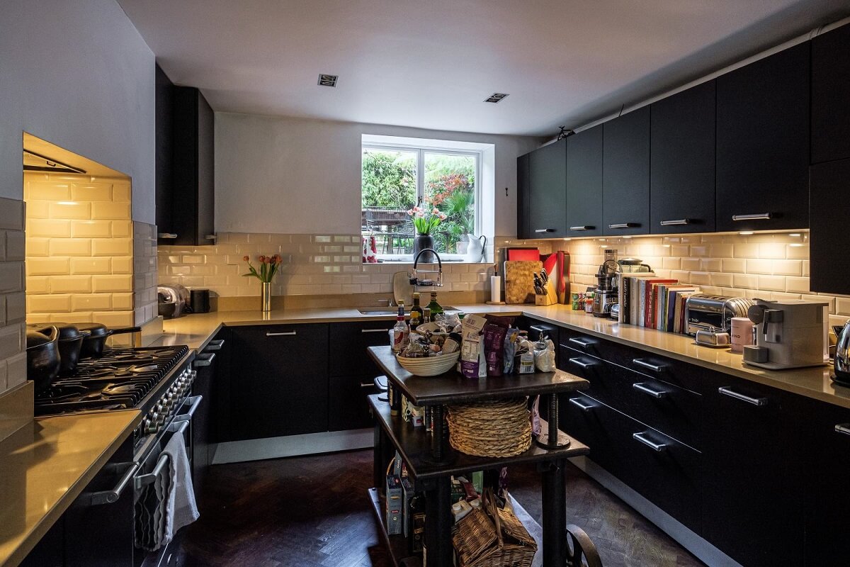 Moody Gray Tones and Period Details in a Victorian Townhouse 9 black kitchen