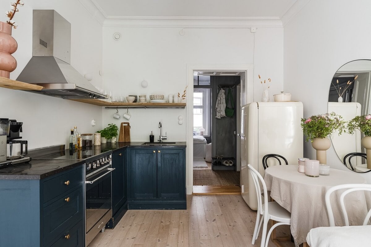 A Small Stockholm Apartment with a Gray Bedroom & Sunny Balcony 4 blue kitchen with small table