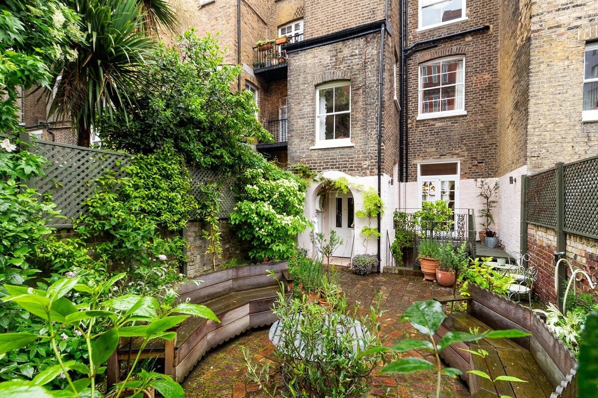 Limewash Paint and Artisan Wallpaper in a London Townhouse 47 city garden with wooden benches