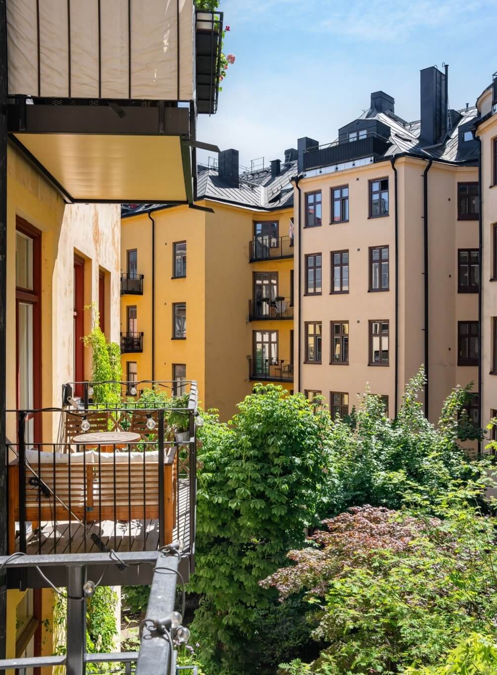 A Small Stockholm Apartment with a Gray Bedroom & Sunny Balcony 16 courtyard balcony A Small Stockholm Apartment with a Gray Bedroom & Sunny Balcony