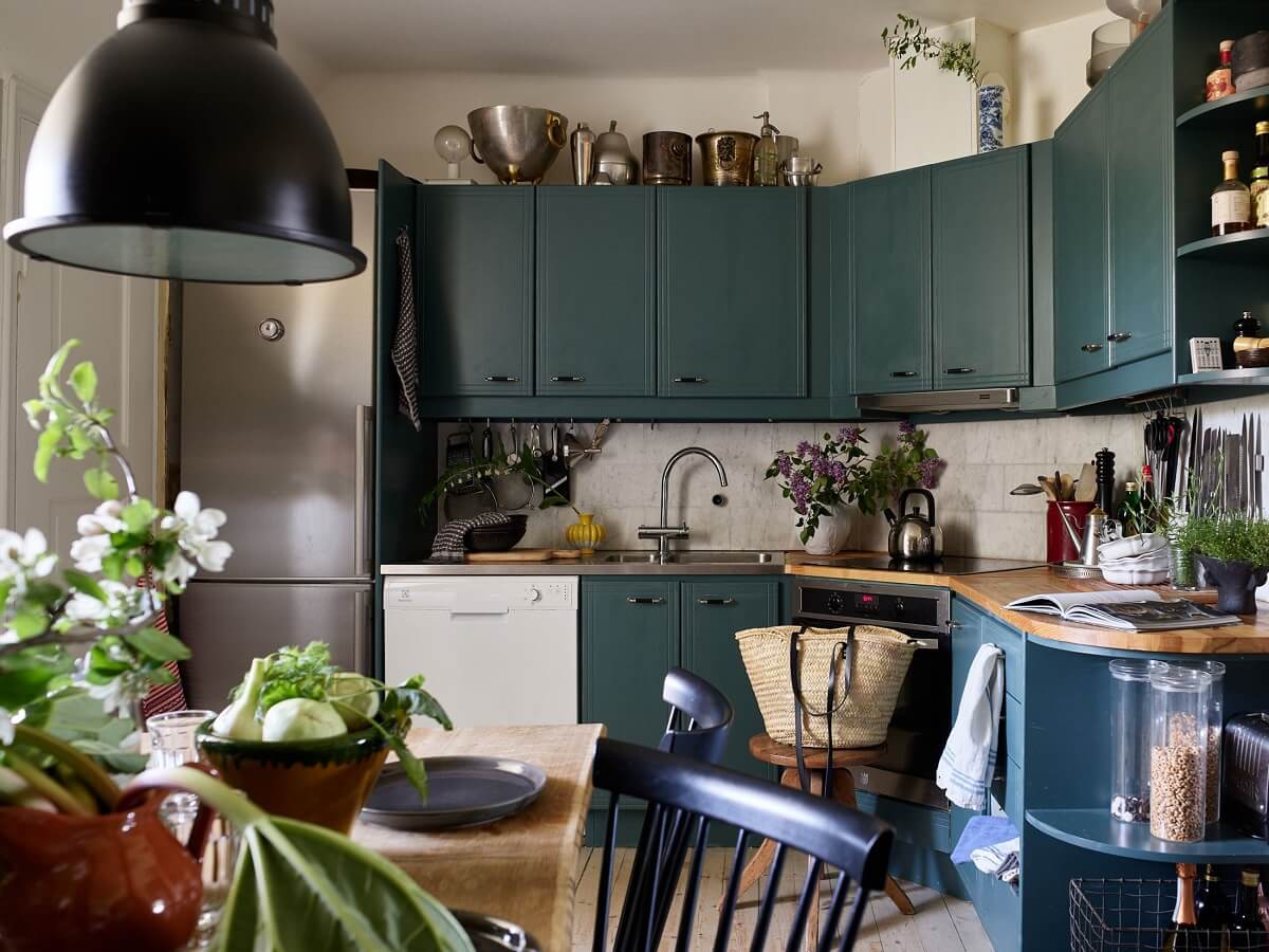 A Cozy Attic Apartment is a Charming Family Home 14 cozy cluttered kitchen with blue cabinets