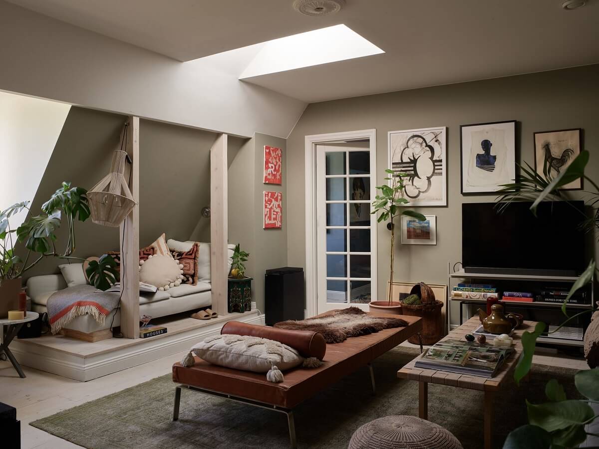 A Cozy Attic Apartment is a Charming Family Home 1 cozy living room with slanted ceiling and skylight