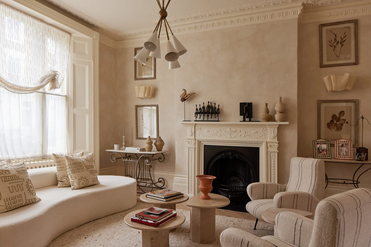 Limewash Paint and Artisan Wallpaper in a London Townhouse 12 curved sofa in light colored sitting room with fireplace