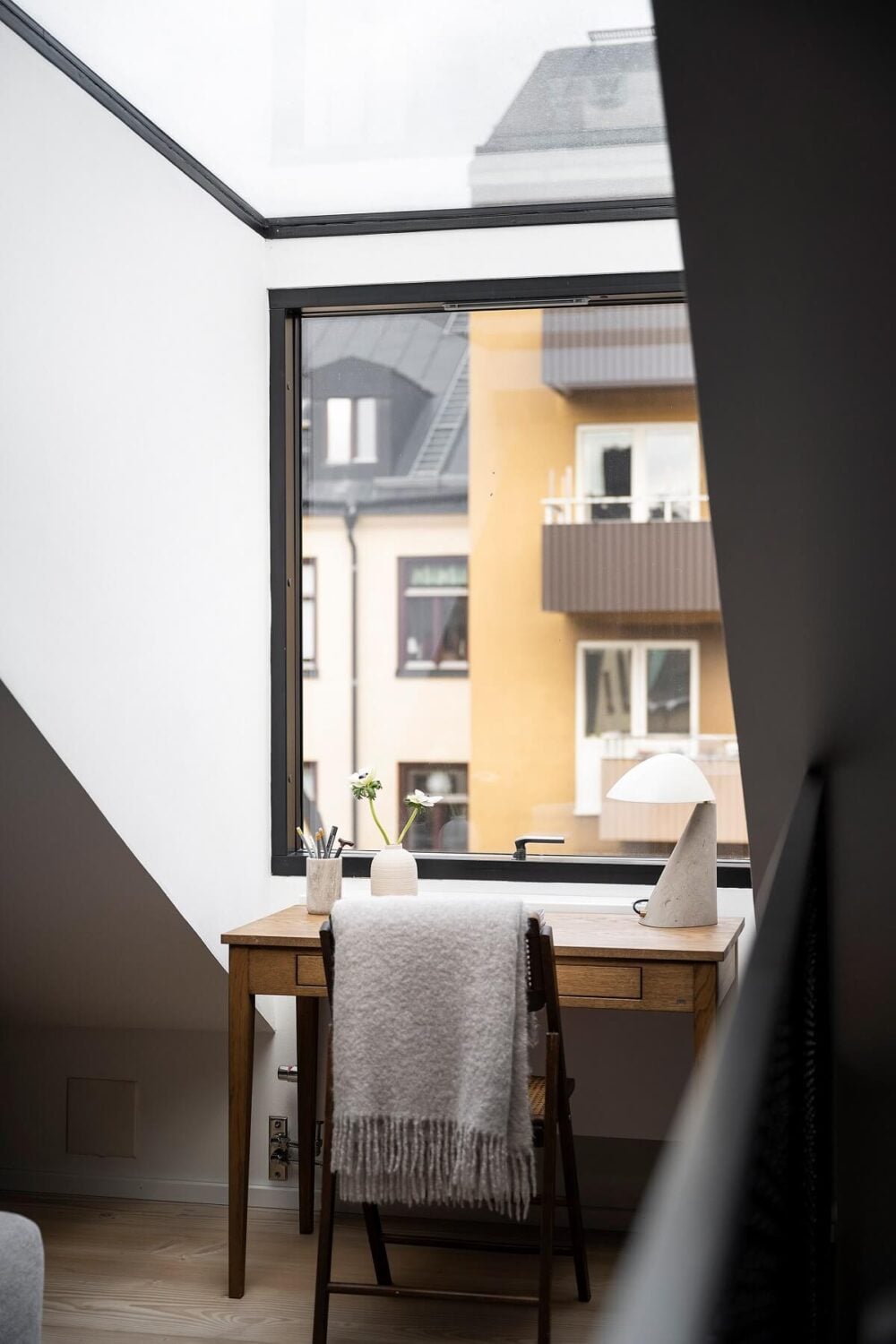 A Stylish Scandinavian Duplex with Custom-Made Cabinets 17 desk in front of window