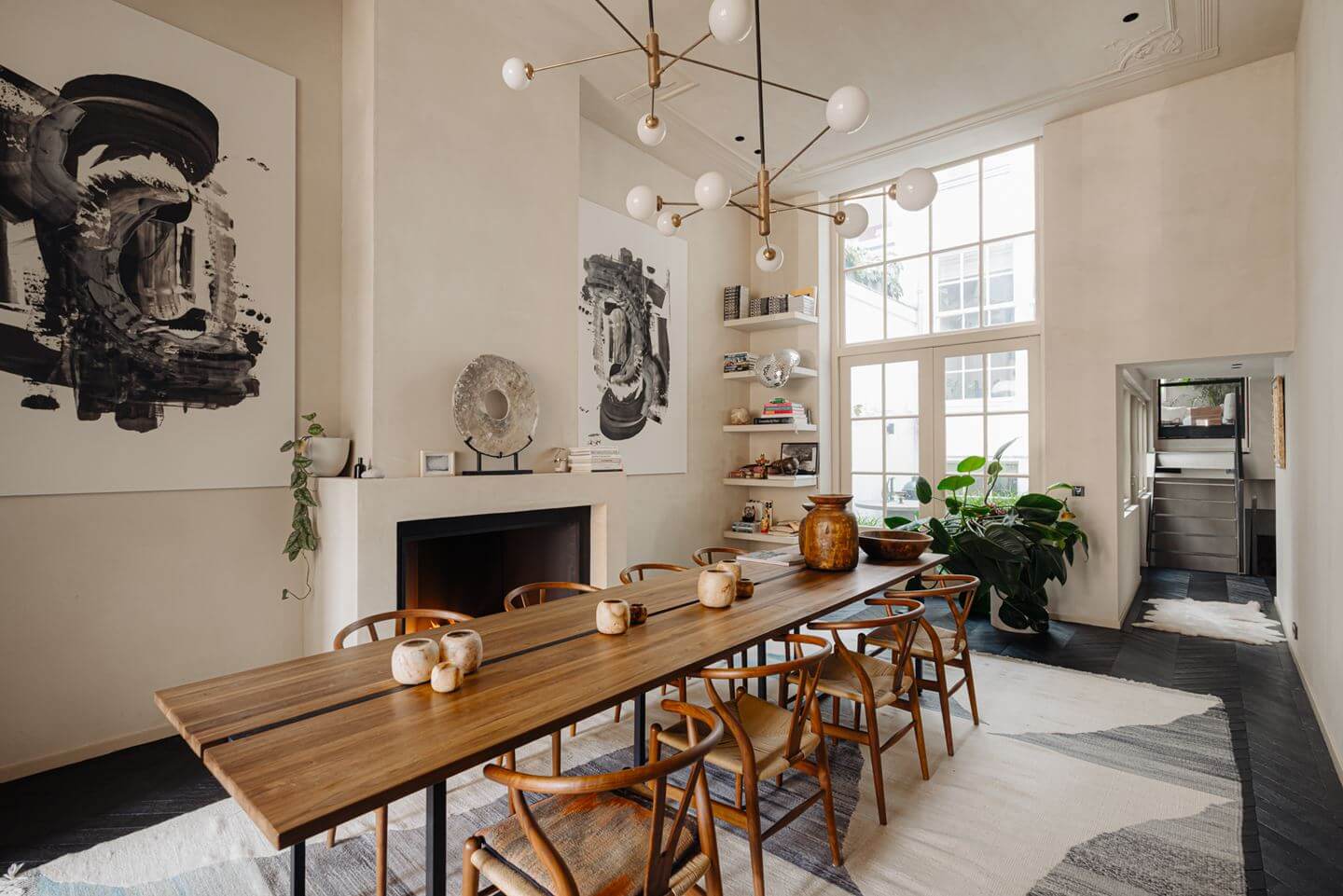 A Luxurious Apartment in an Amsterdam Canal House 2 dining room with wishbone chairs and fireplace