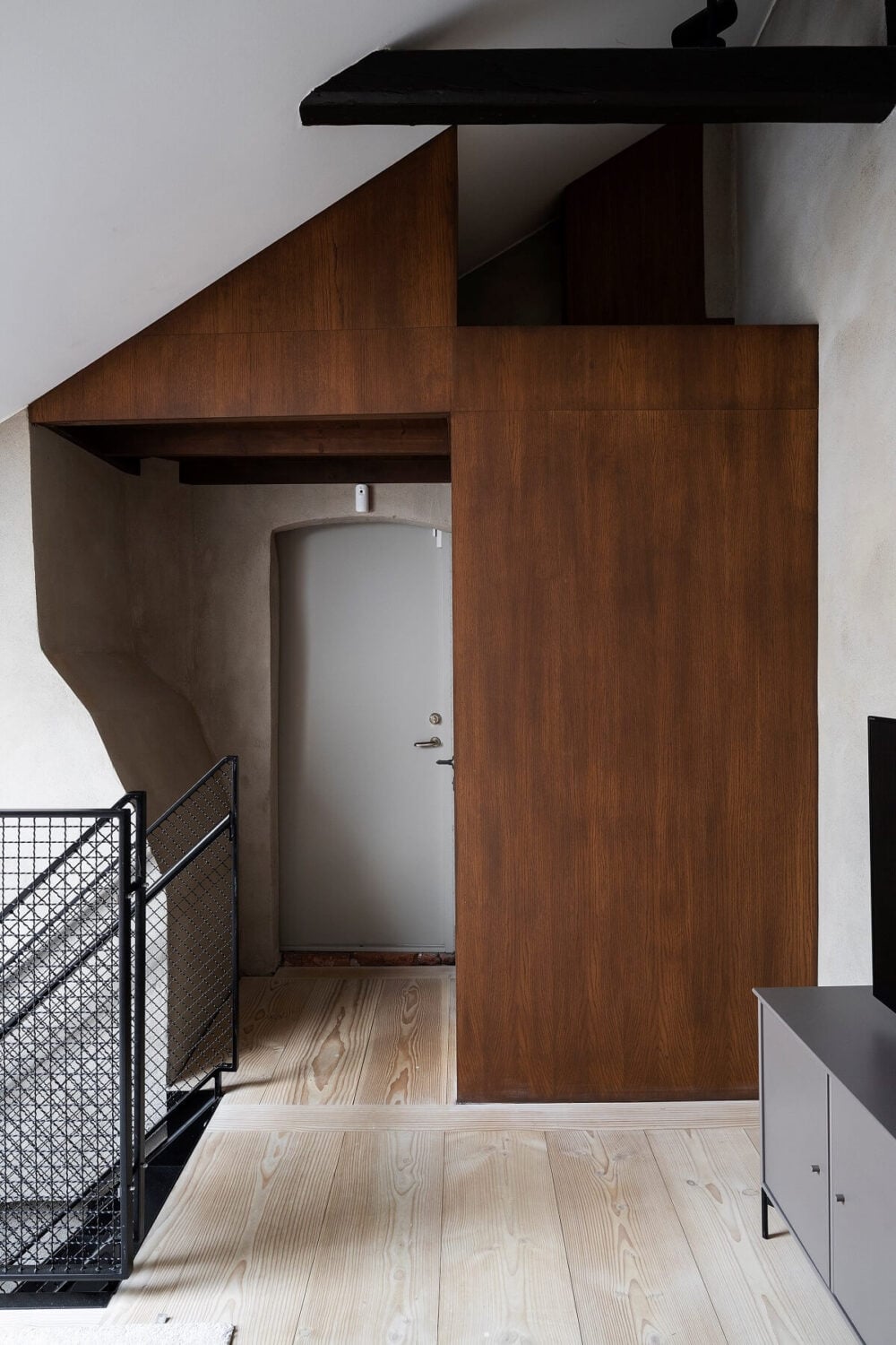 A Stylish Scandinavian Duplex with Custom-Made Cabinets 24 first floor landing with wooden cabinets
