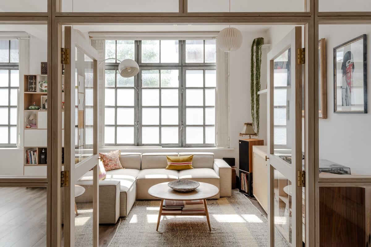 A Modern Scandinavian-Style Apartment in a Former London Mill 1 glass doors opened up into sitting room with industrial window