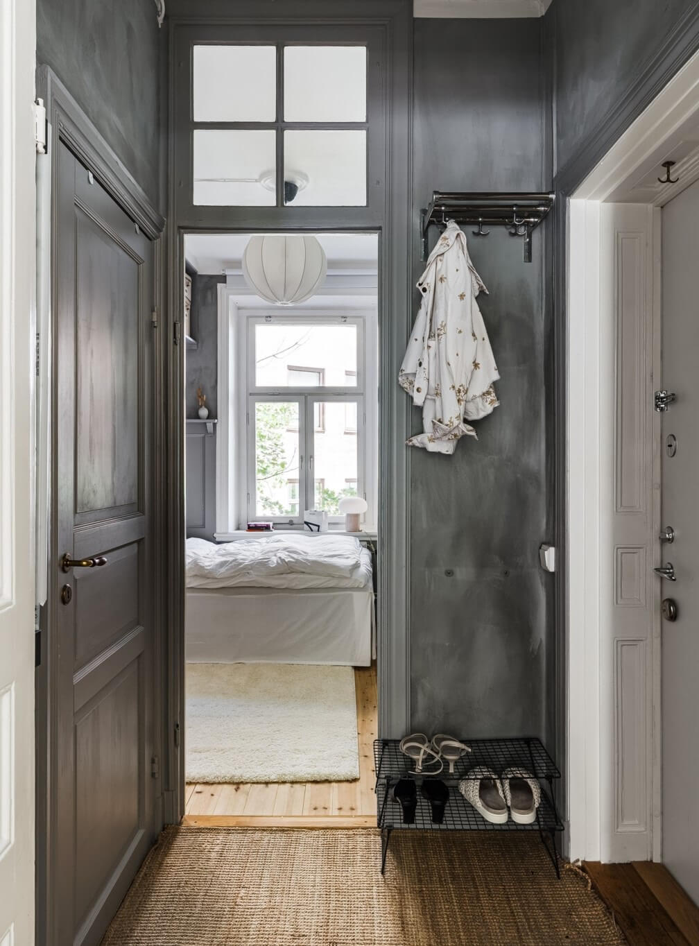 A Small Stockholm Apartment with a Gray Bedroom & Sunny Balcony 11 gray hallway with coat and shoe storage