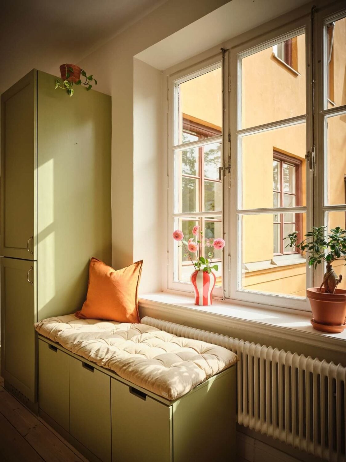 A Light Apartment with a Sage Green Kitchen 8 green window seat A Light Apartment with a Sage Green Kitchen