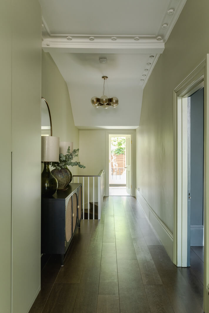 A Green Living Room in a London Maisonette 10 hallway with green walls and storage