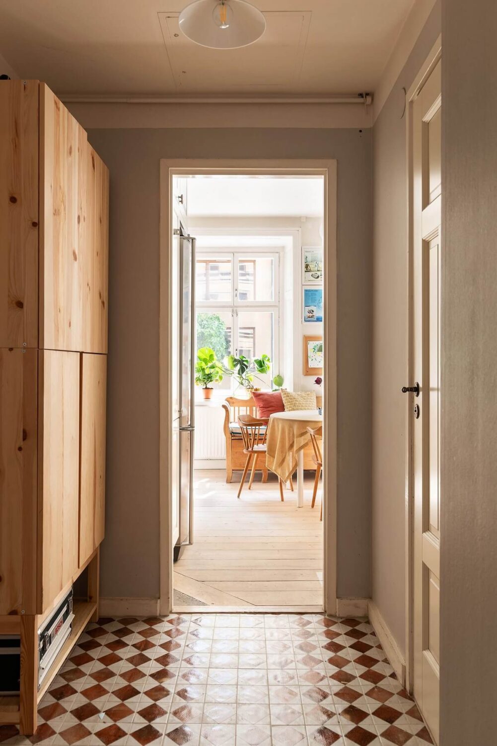 Light and Charming Rooms in a Historic Stockholm Apartment 13 hallway with ikea ivar cabinets and red white checkerboard floor nordroom