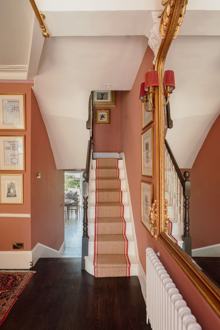 Rich Colors and Patterns in a London Townhouse 23 hallway with staircase and pink walls