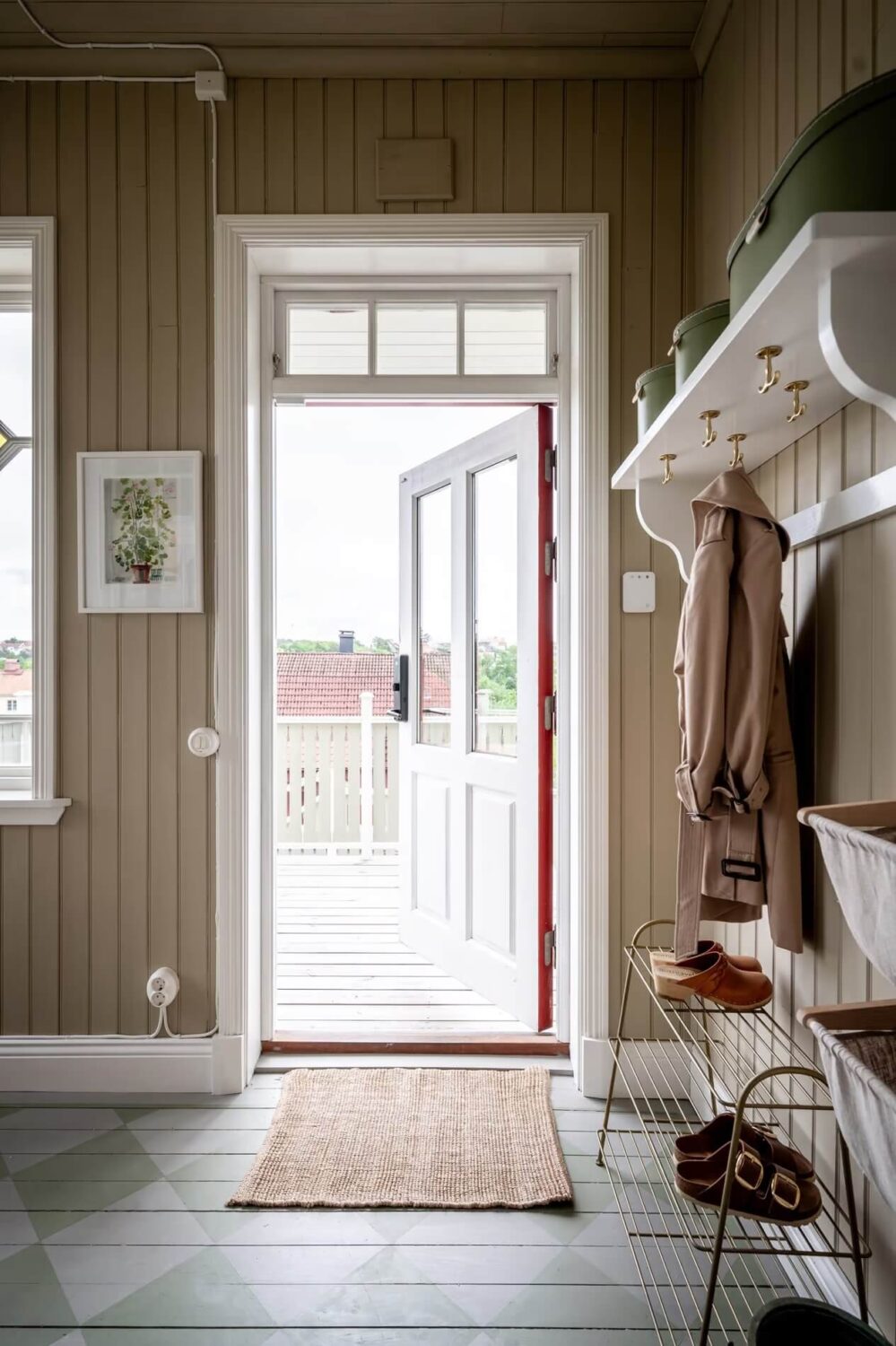 Original Charm in a Light Green Swedish Country House 15 hallway with storage baskets