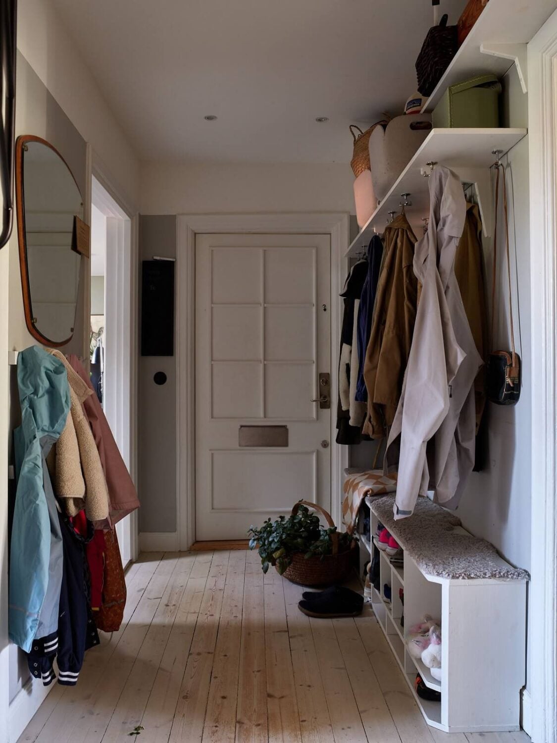 A Cozy Attic Apartment is a Charming Family Home 26 hallway with wooden floor and storage