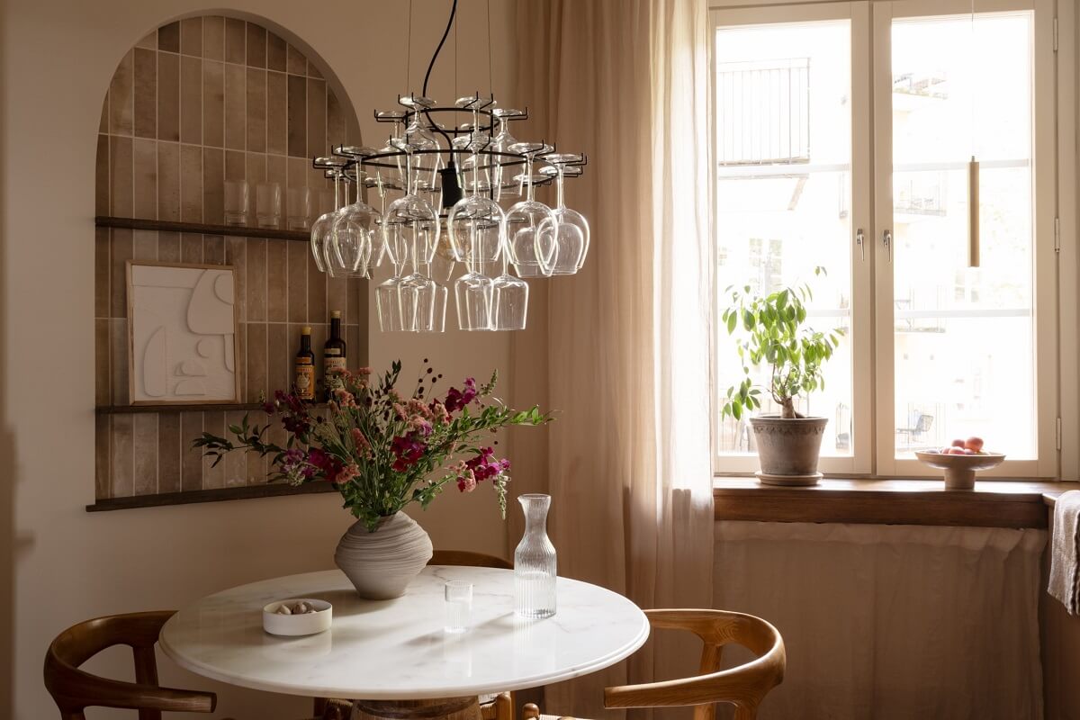Warm Colors and Painted Ceilings in a Swedish Apartment 5 kitchen round table arched tiled niche