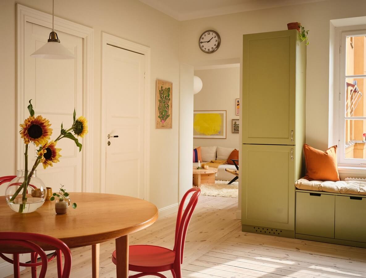 A Light Apartment with a Sage Green Kitchen 9 kitchen with green cabinets and round table A Light Apartment with a Sage Green Kitchen