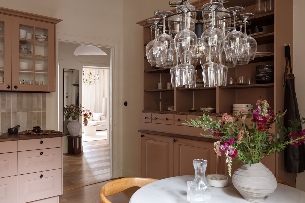 Warm Colors and Painted Ceilings in a Swedish Apartment 9 kitchen with open and closed cabinets