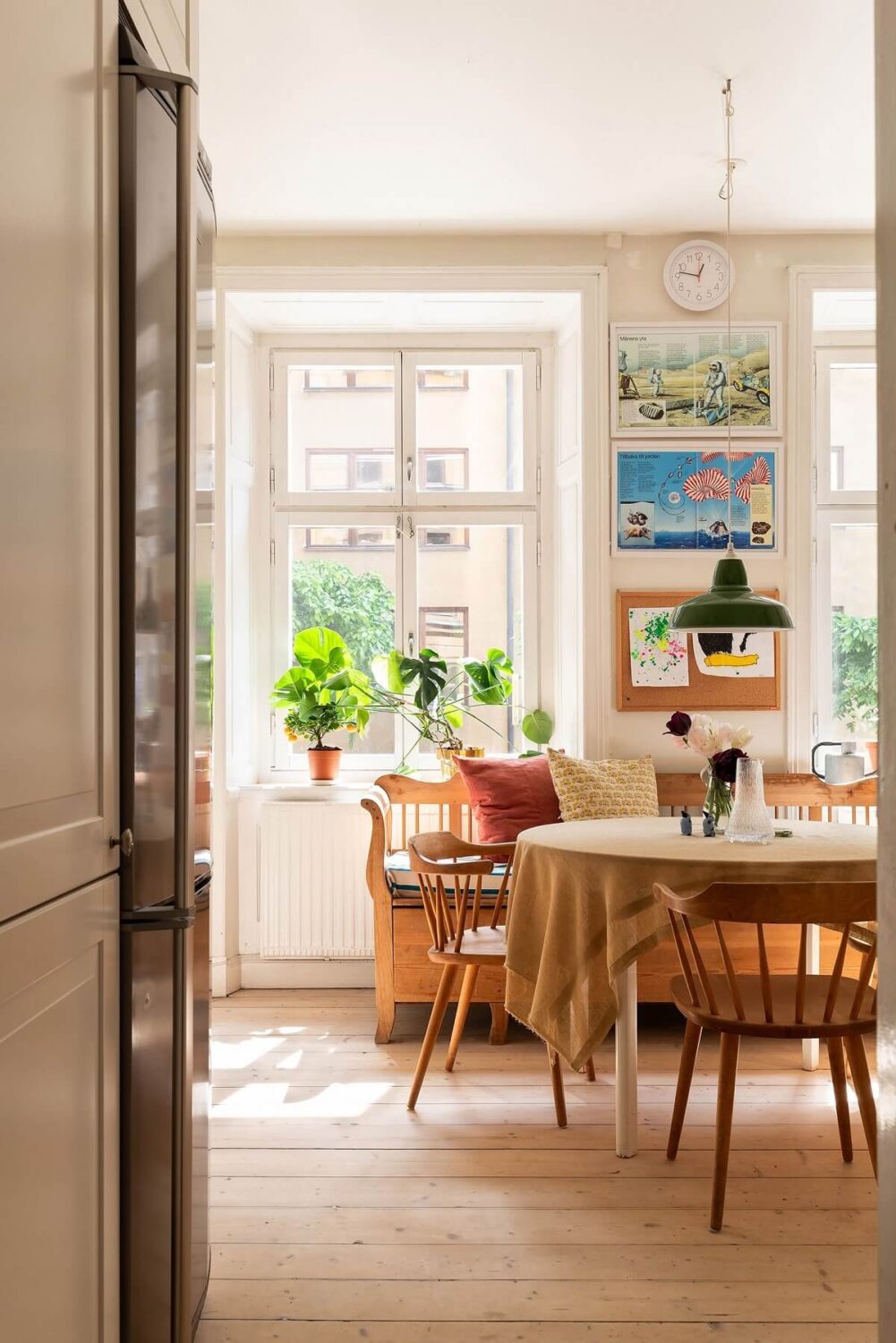 Light and Charming Rooms in a Historic Stockholm Apartment 12 kitchen with round table and wooden bench nordroom