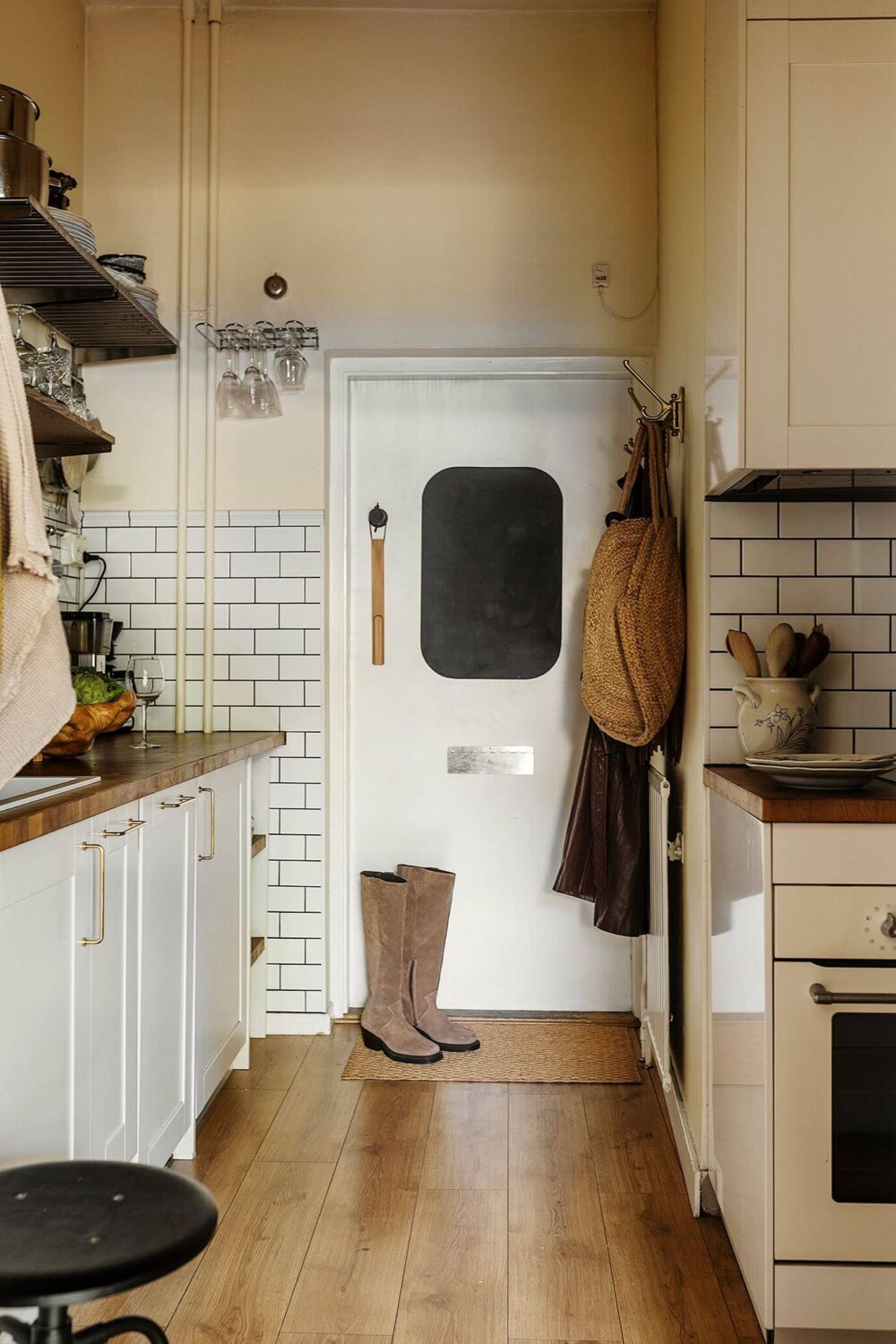 A Charming Studio Apartment with a Loft Bed 11 kitchen with white subway tiles
