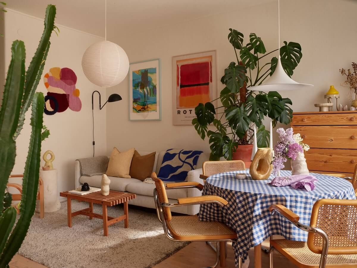 A Small Light Filled Apartment with Plants and Color 5 light scandi living room with dining table and plants