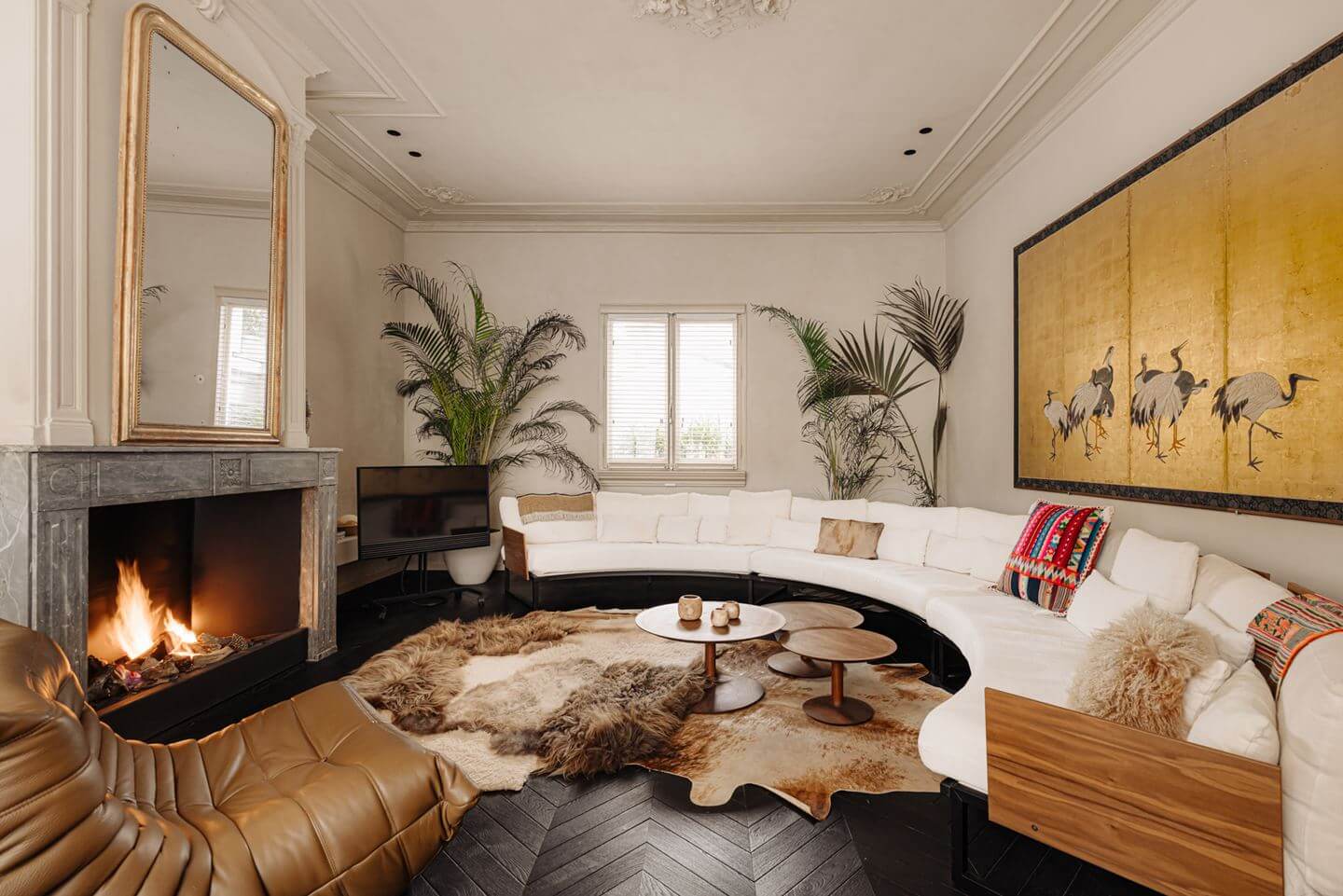 A Luxurious Apartment in an Amsterdam Canal House 12 living room curved sofa black chevron floor fireplace