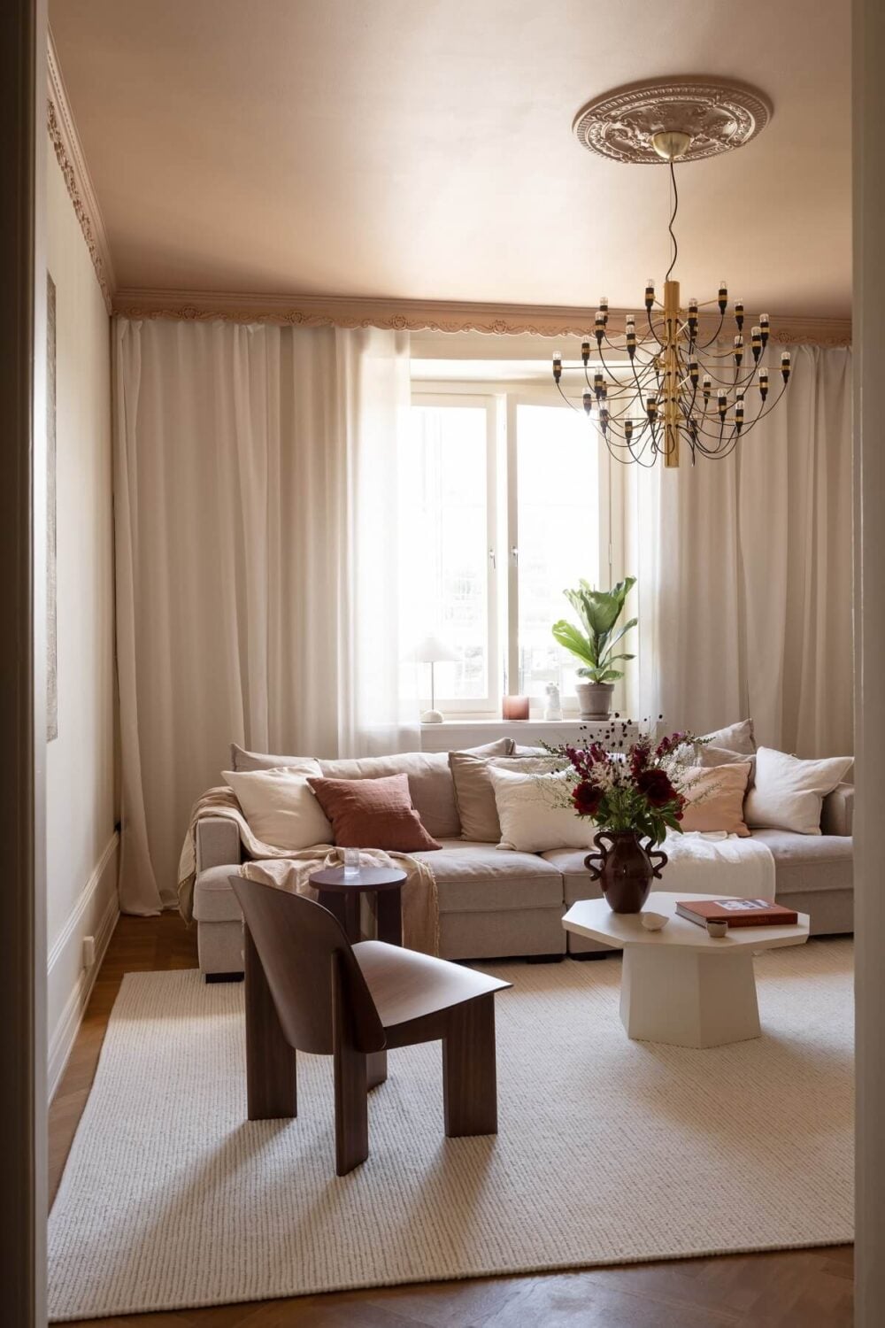 Warm Colors and Painted Ceilings in a Swedish Apartment 1 living room warm pink ceiling