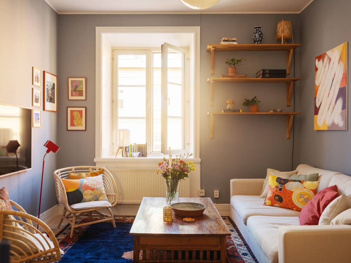 A Light Apartment with a Sunny Balcony 2 living room with bold blue rug and shelves