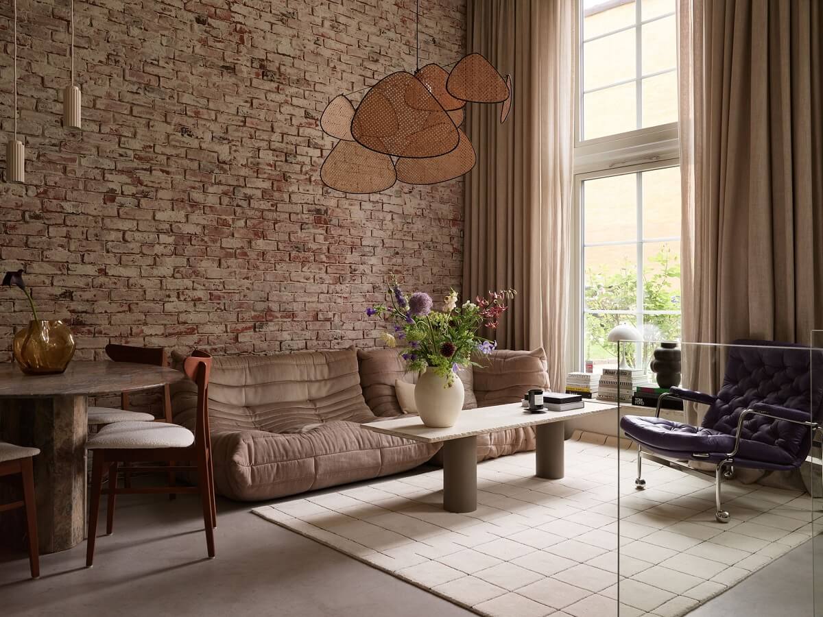 New York Vibes in a Stylish Stockholm Apartment 7 living room with exposed brick wall