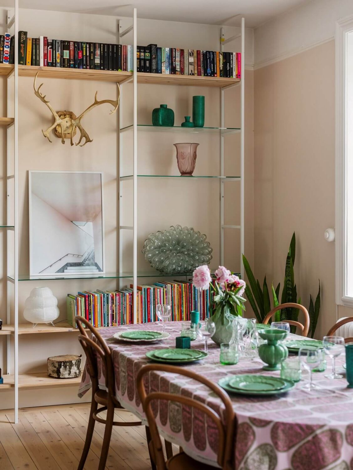 A Light Atmosphere and Wallpapers in a Swedish Apartment 5 living room with floor to ceiling shelves nordroom