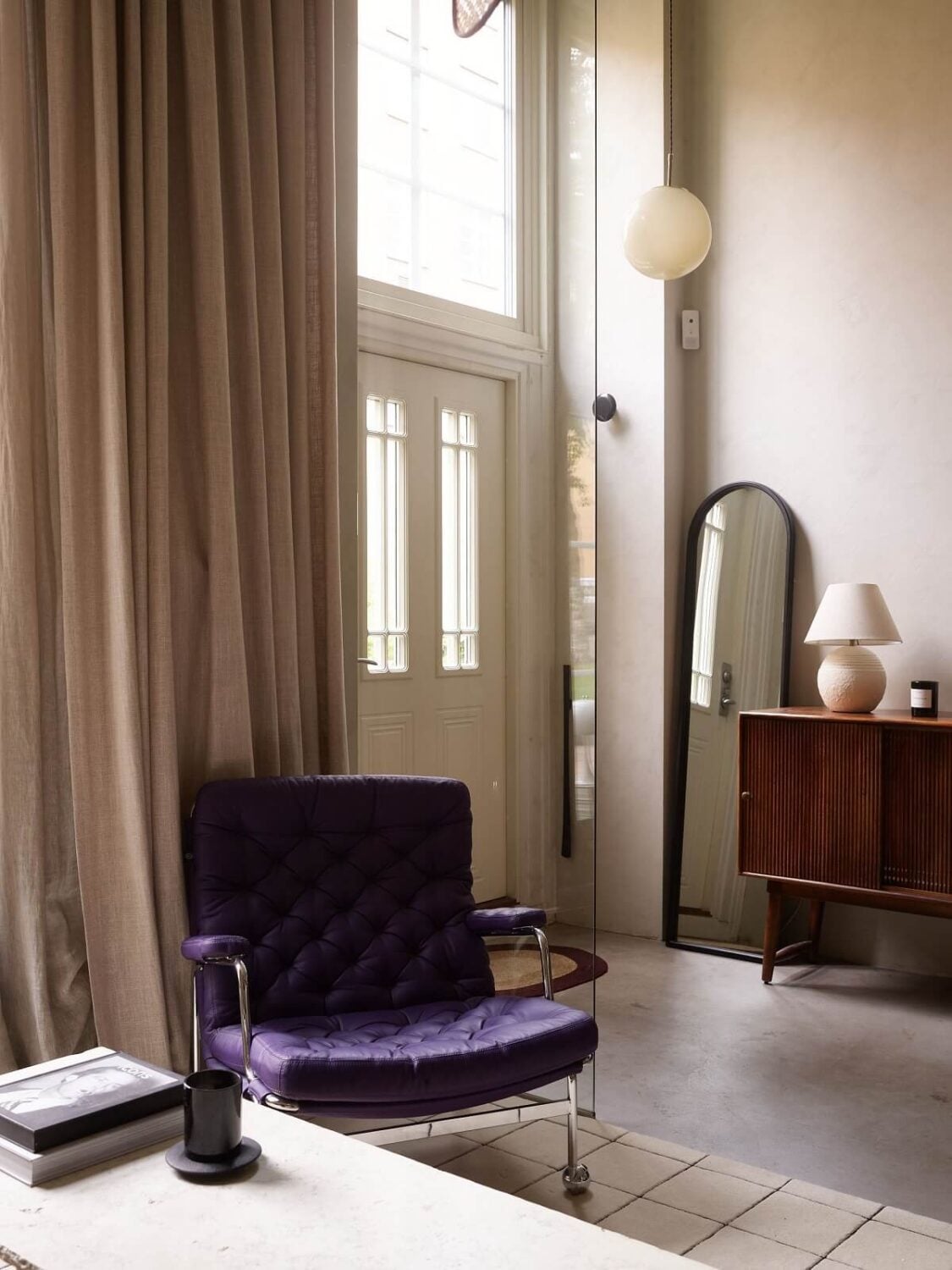 New York Vibes in a Stylish Stockholm Apartment 6 living room with glass divider wall to hallway