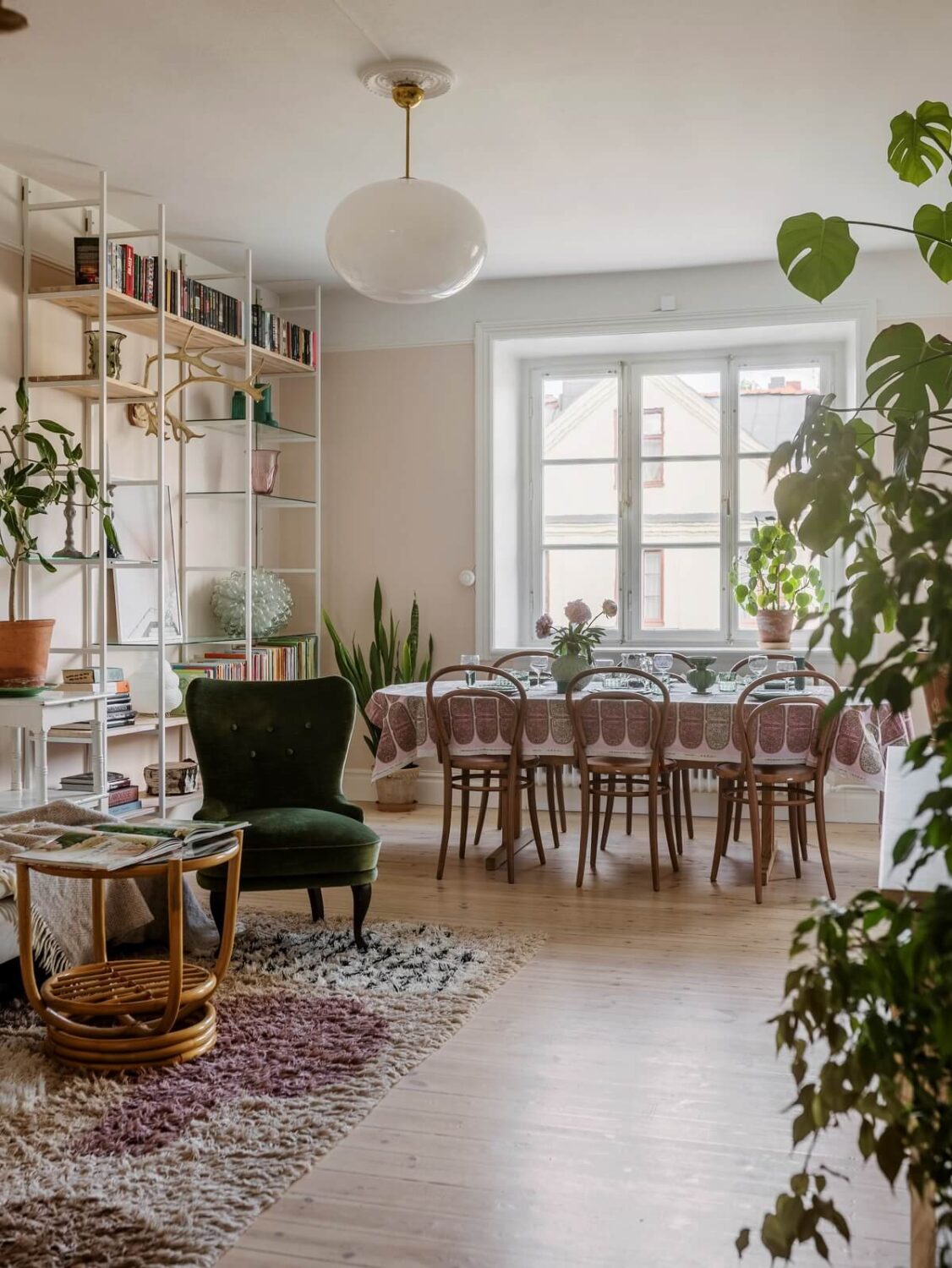 A Light Atmosphere and Wallpapers in a Swedish Apartment 4 living room with shelves and dining table nordroom