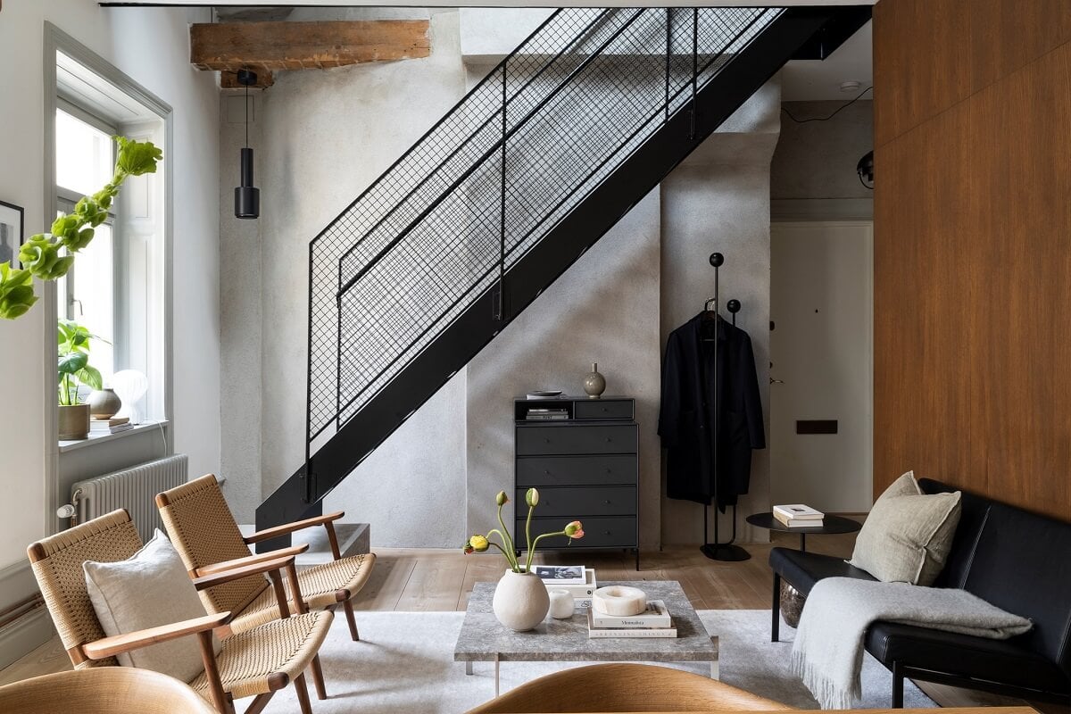 A Stylish Scandinavian Duplex with Custom-Made Cabinets 7 living room with steel staircase