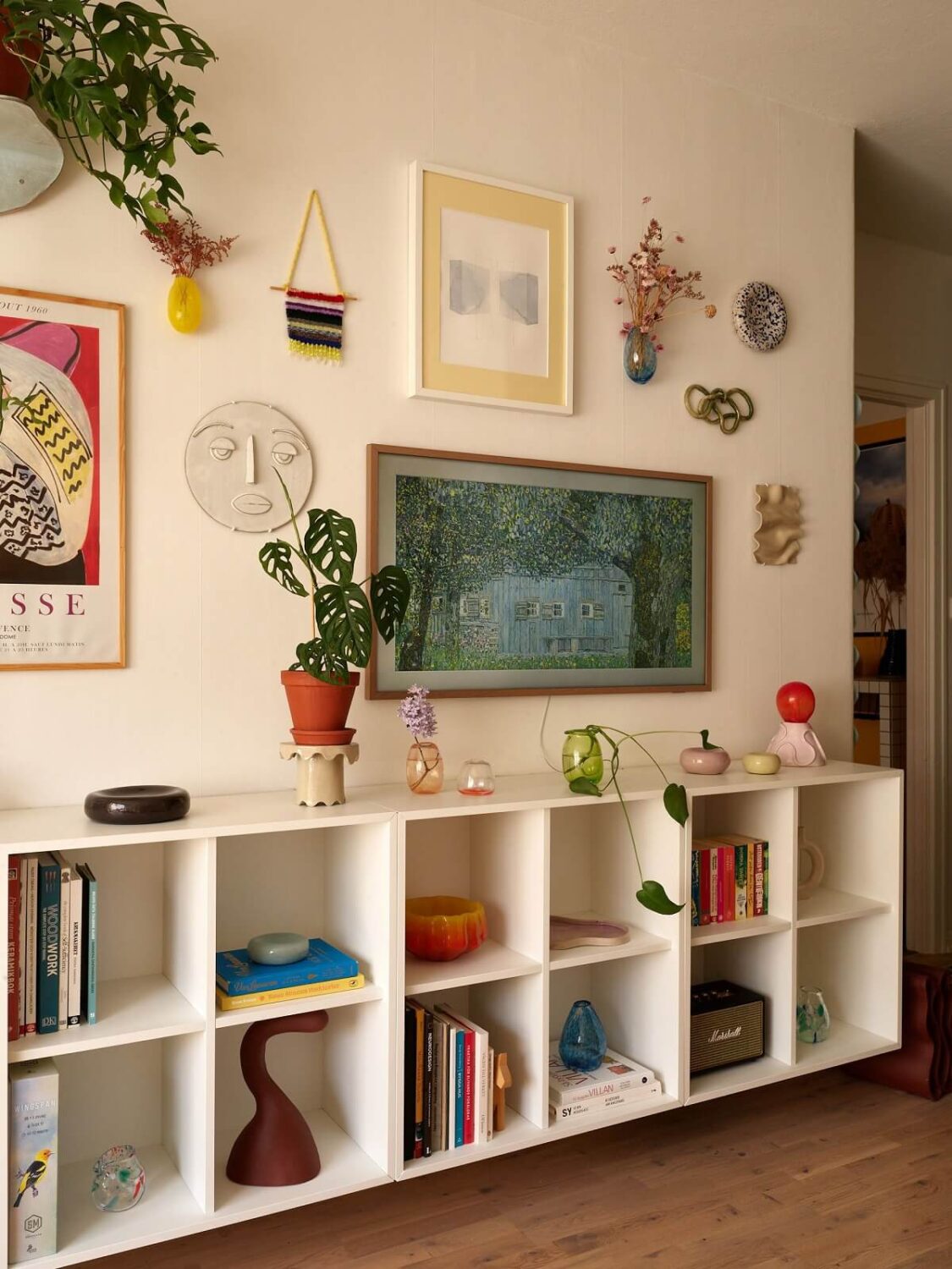 A Small Light Filled Apartment with Plants and Color 6 living room with white open cabinets nordroom