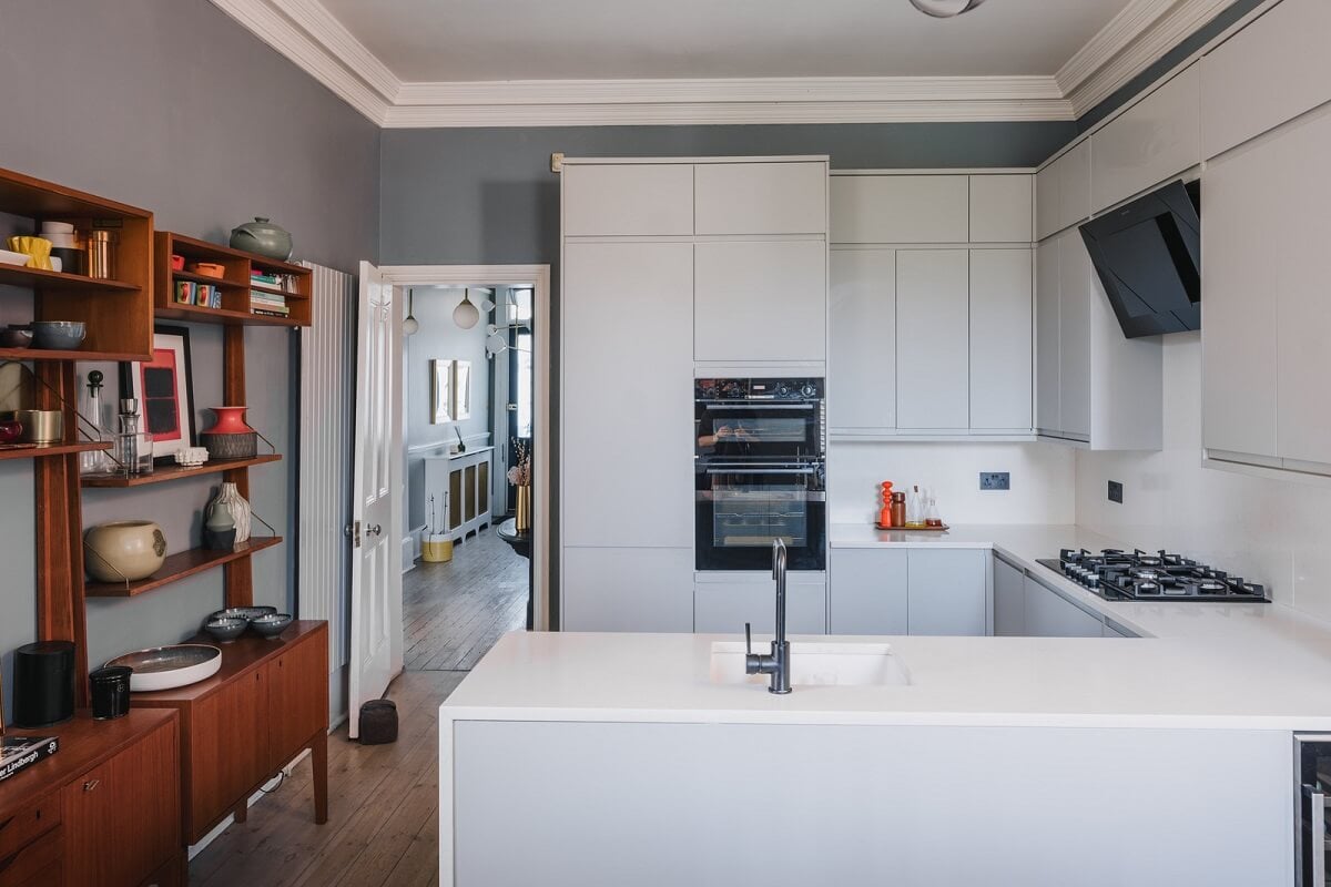 A Deep Blue Color Palette in a London Apartment 4 modern white kitchen