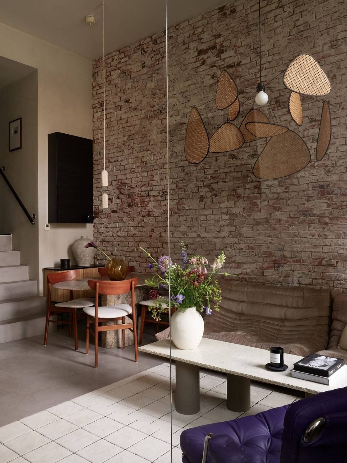 New York Vibes in a Stylish Stockholm Apartment 10 nordic living room with brick wall and high ceilings
