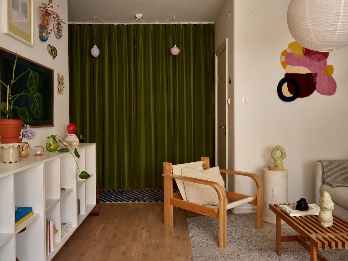 A Small Light Filled Apartment with Plants and Color 18 open living room and hallway with green curtain nordroom
