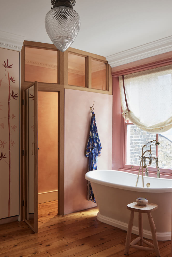 Limewash Paint and Artisan Wallpaper in a London Townhouse 30 pink bathroom with freestanding bath and wooden floor nordroom